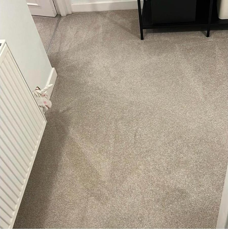 Beige carpet in a room, beside a white radiator.